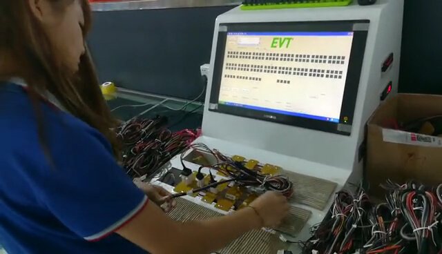 Operator using Wire Harness Color Sequence and Continuity Tester during color sequence and continuity inspection